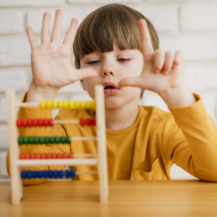 front-view-child-using-abacus-learn-how-count (1) front-view-child-using-abacus-learn-how-count (1)